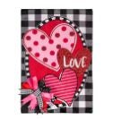 A garden flag with pink hearts on a buffalo check background