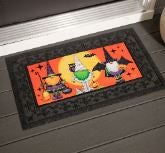 A Halloween Gnome Sassafras interchangeable Doormat by a front door