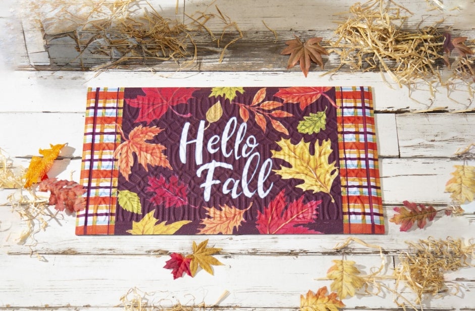 a red yellow and orange door mat with Fall leaves on it 